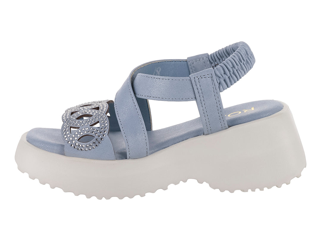 Sandalia azul para niña con suela de plataforma blanca y adorno frontal.