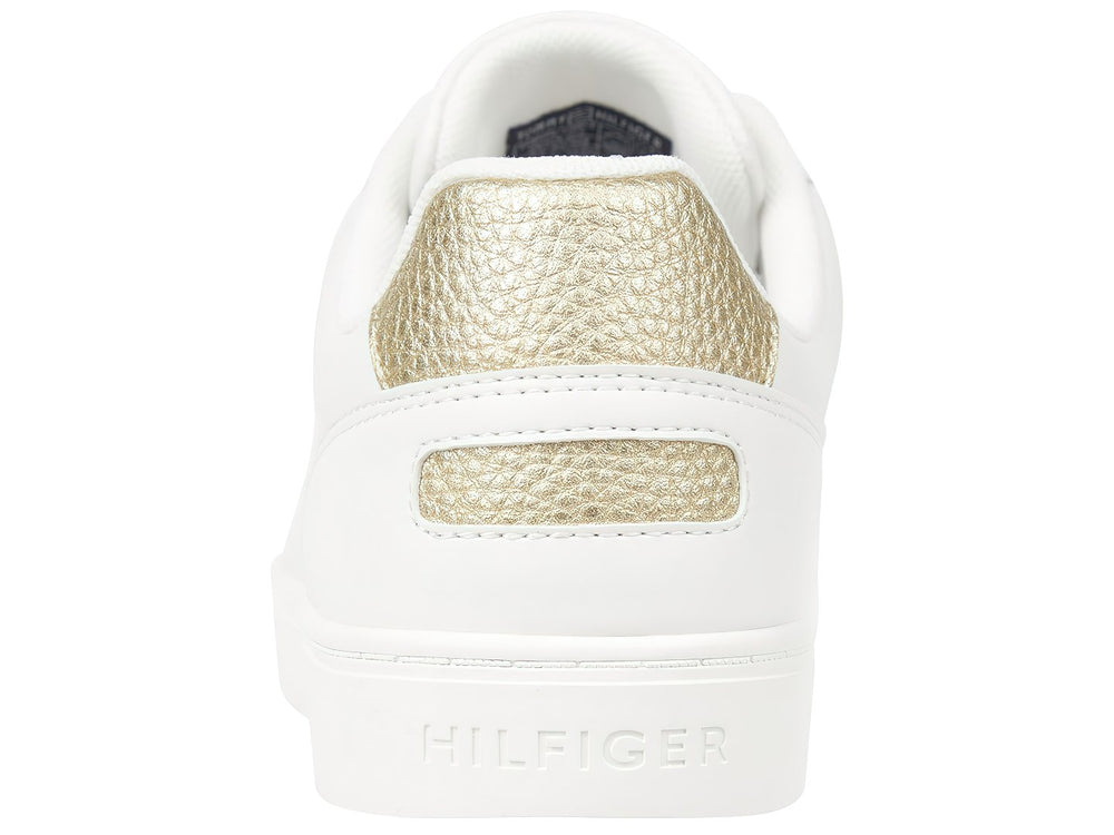 Tenis Tommy Hilfiger color blanco con detalle dorado en el talón y suela blanca.