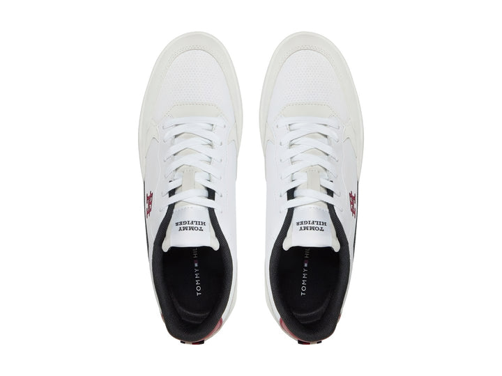 Tenis blancos Tommy Hilfiger con detalles en gris y azul marino y suela blanca.
