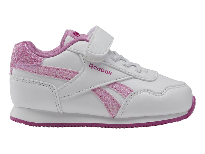 Tenis blancos Reebok para niña con detalles en rosa brillante y suela rosa.