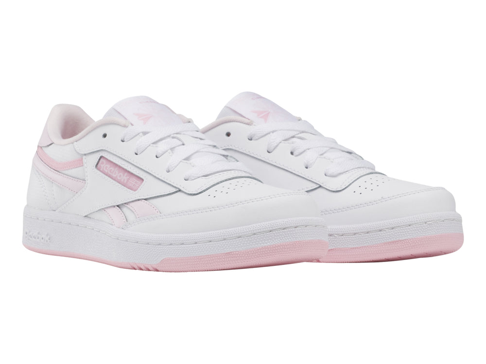 Tenis Reebok blancos con detalles y suela en color rosa, estilo casual deportivo.