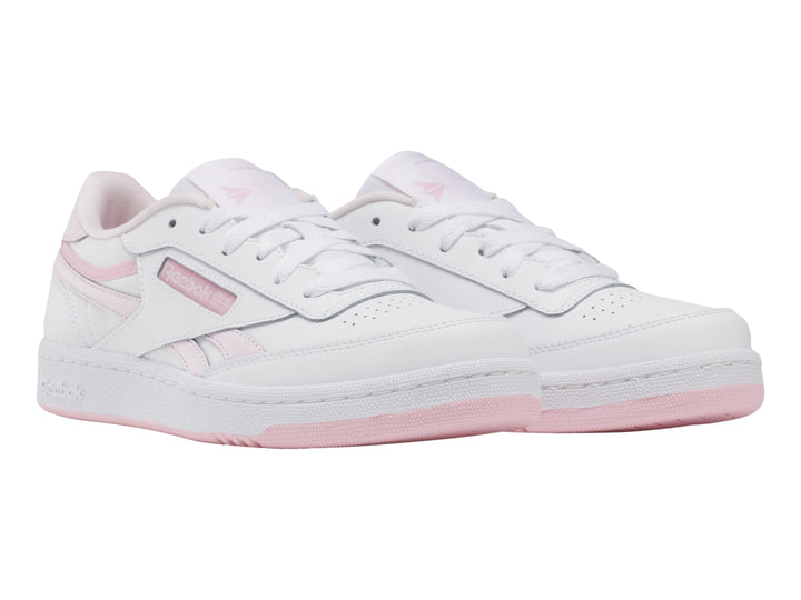 Tenis Reebok blancos con detalles y suela en color rosa, estilo casual deportivo.