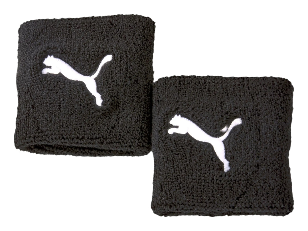 Par de muñequeras deportivas PUMA en color negro con el logotipo del gato blanco bordado.