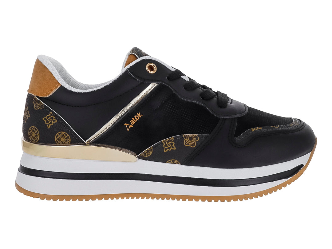Tenis ATOK color negro con detalles dorados y suela blanca y café.
