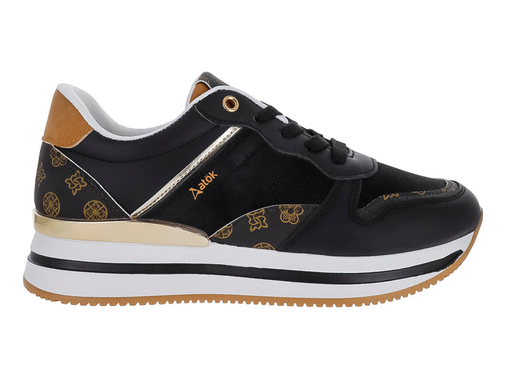 Tenis ATOK color negro con detalles dorados y suela blanca y café.