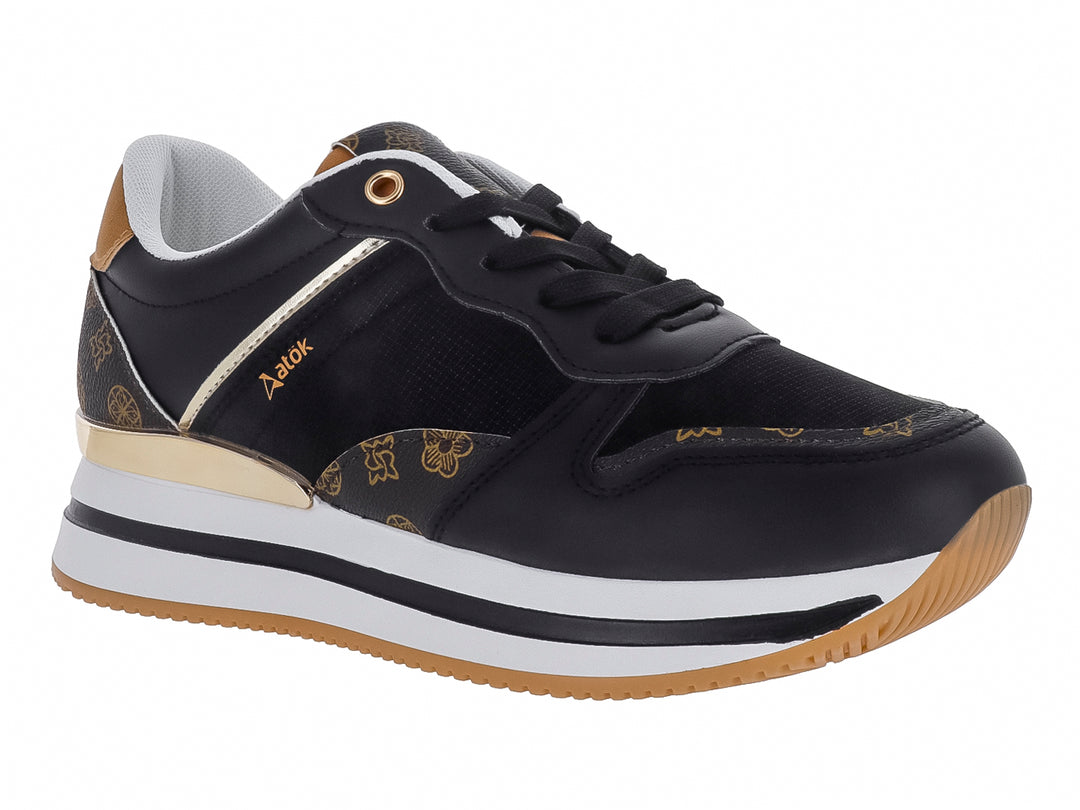 Tenis ATOK color negro con detalles dorados y suela blanca y café.
