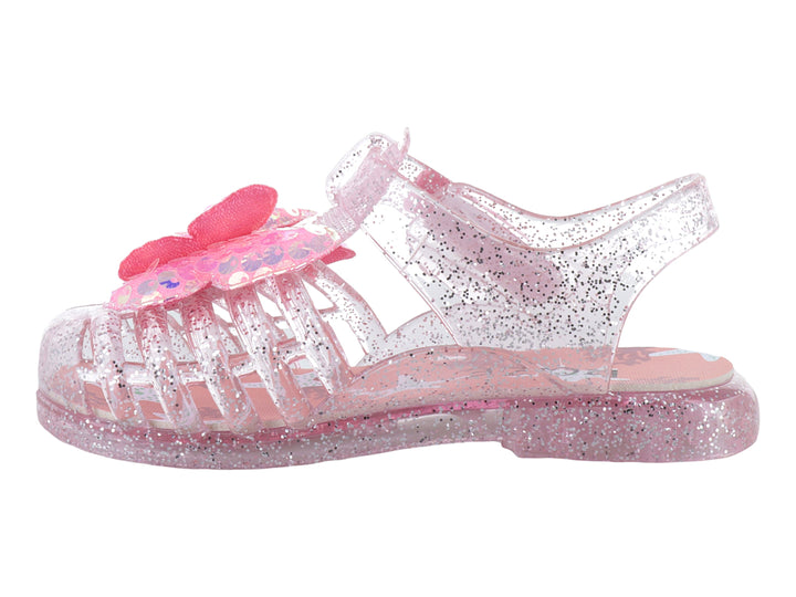 Sandalias infantiles color rosa con glitter, material transparente y un moño decorativo en la parte superior.