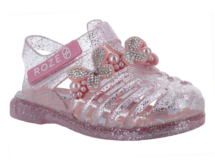 Sandalias infantiles color rosa con glitter, detalle de moño con perlas y correa ajustable marca ROZE.