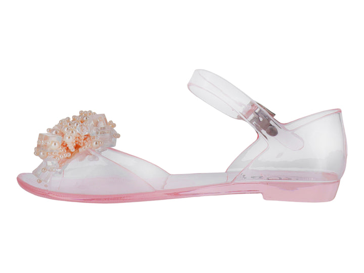 Sandalia transparente para niña con detalles de perlas decorativas en la punta y correa ajustable rosa.