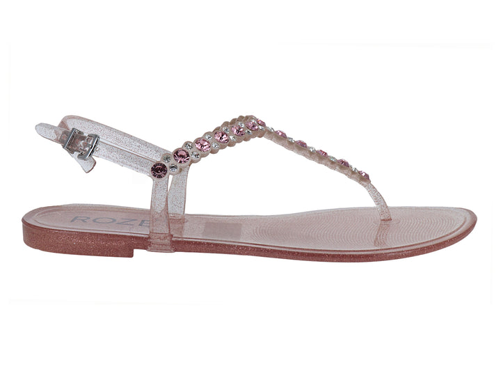Sandalia plana color rosa con glitter y detalles de cuentas brillantes para niña.