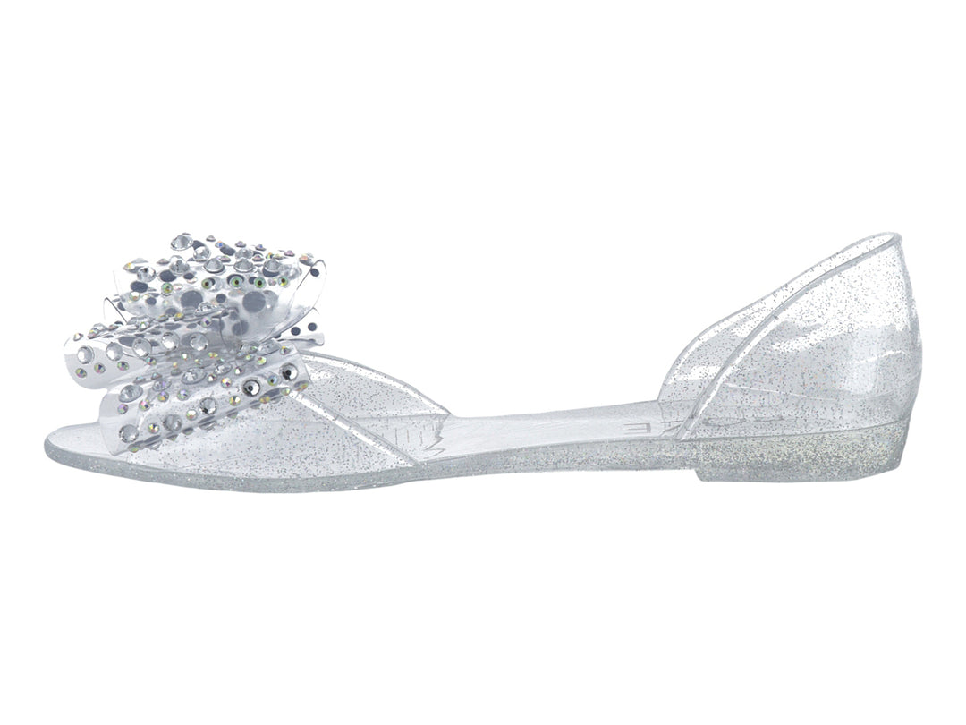 Zapato plano transparente con glitter y adorno de pedrería brillante en la punta para niña.
