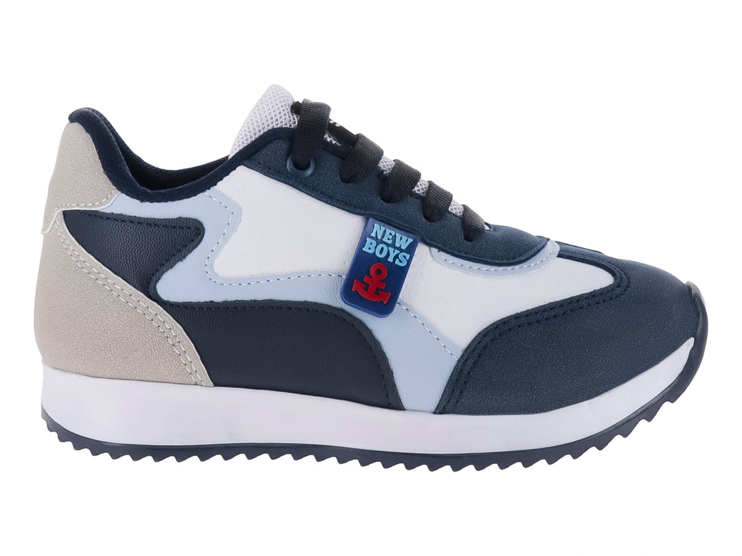 Tenis deportivos para niño en colores azul marino, blanco y gris con suela blanca.