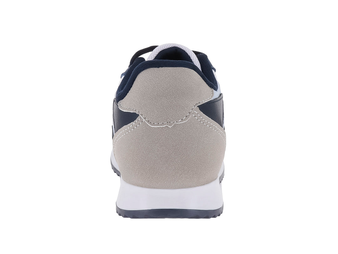 Tenis deportivos para niño en colores azul marino, blanco y gris con suela blanca.
