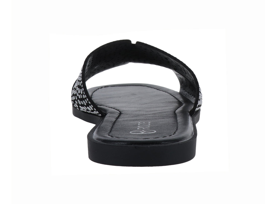 Sandalia slide color negro con correa ancha decorada con relieves circulares.
