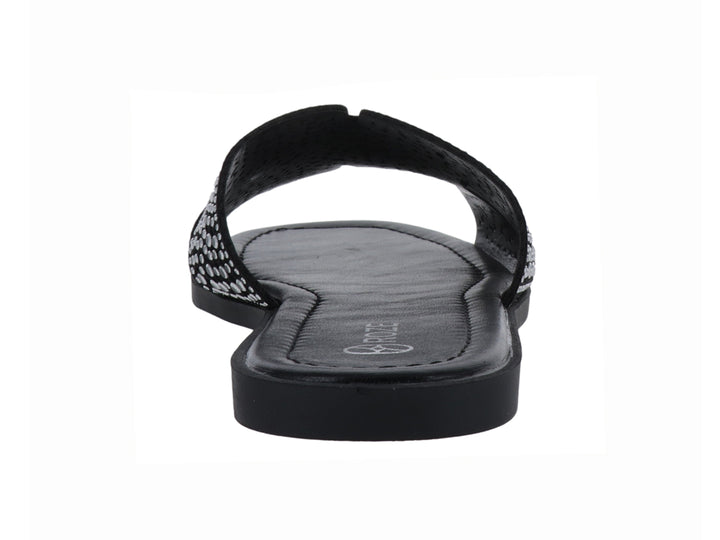 Sandalia slide color negro con correa ancha decorada con relieves circulares.