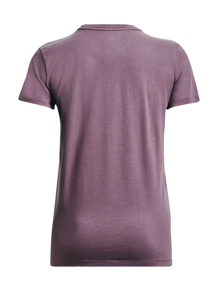 Mujer vistiendo camiseta deportiva morada de manga corta con logo blanco de Under Armour y shorts grises.