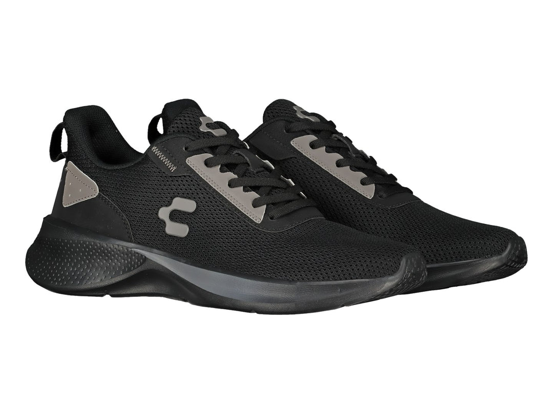 Tenis deportivos Charly color negro con detalles en gris y suela negra.