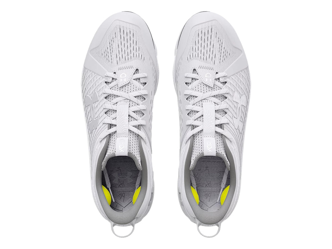 Zapato deportivo Under Armour blanco de corte bajo con tacos grises en la suela.