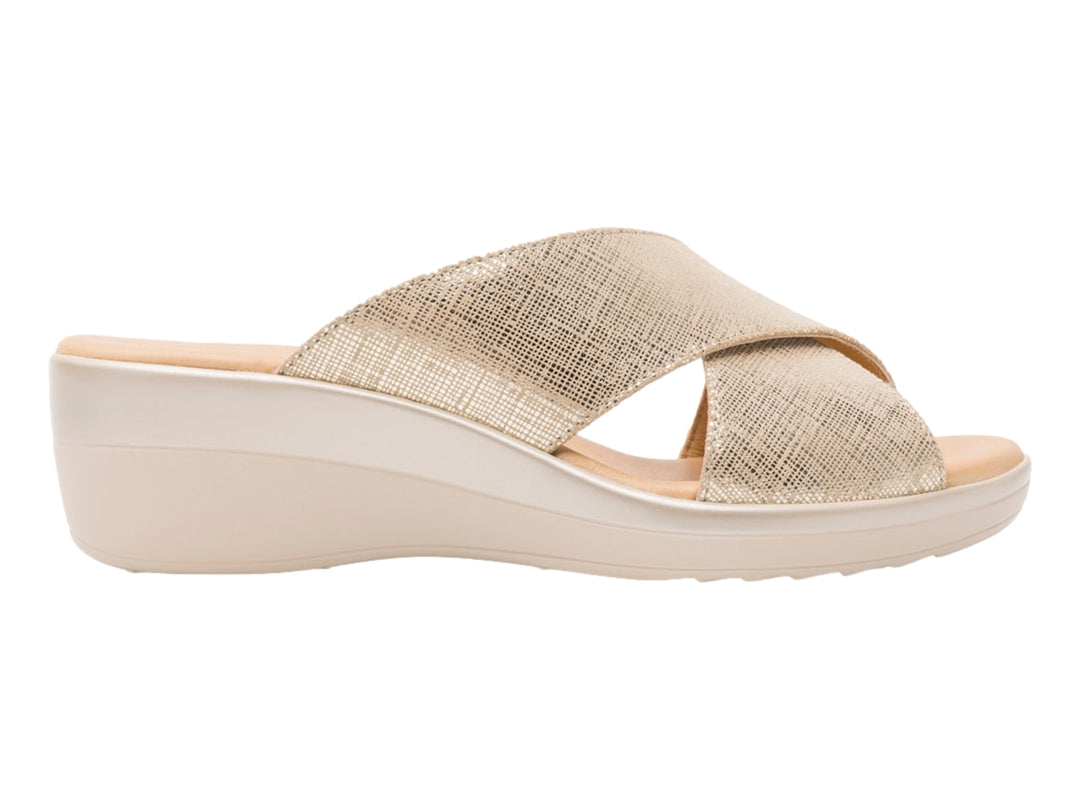 Sandalia Flexi color oro con diseño de tiras cruzadas y plataforma de cuña en tono beige.
