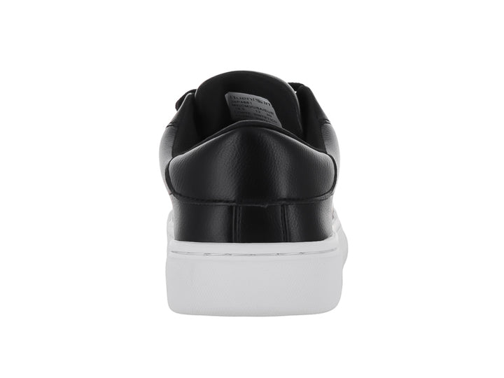 Tenis infantiles de color negro con suela blanca y un detalle rojo en el primer ojal.