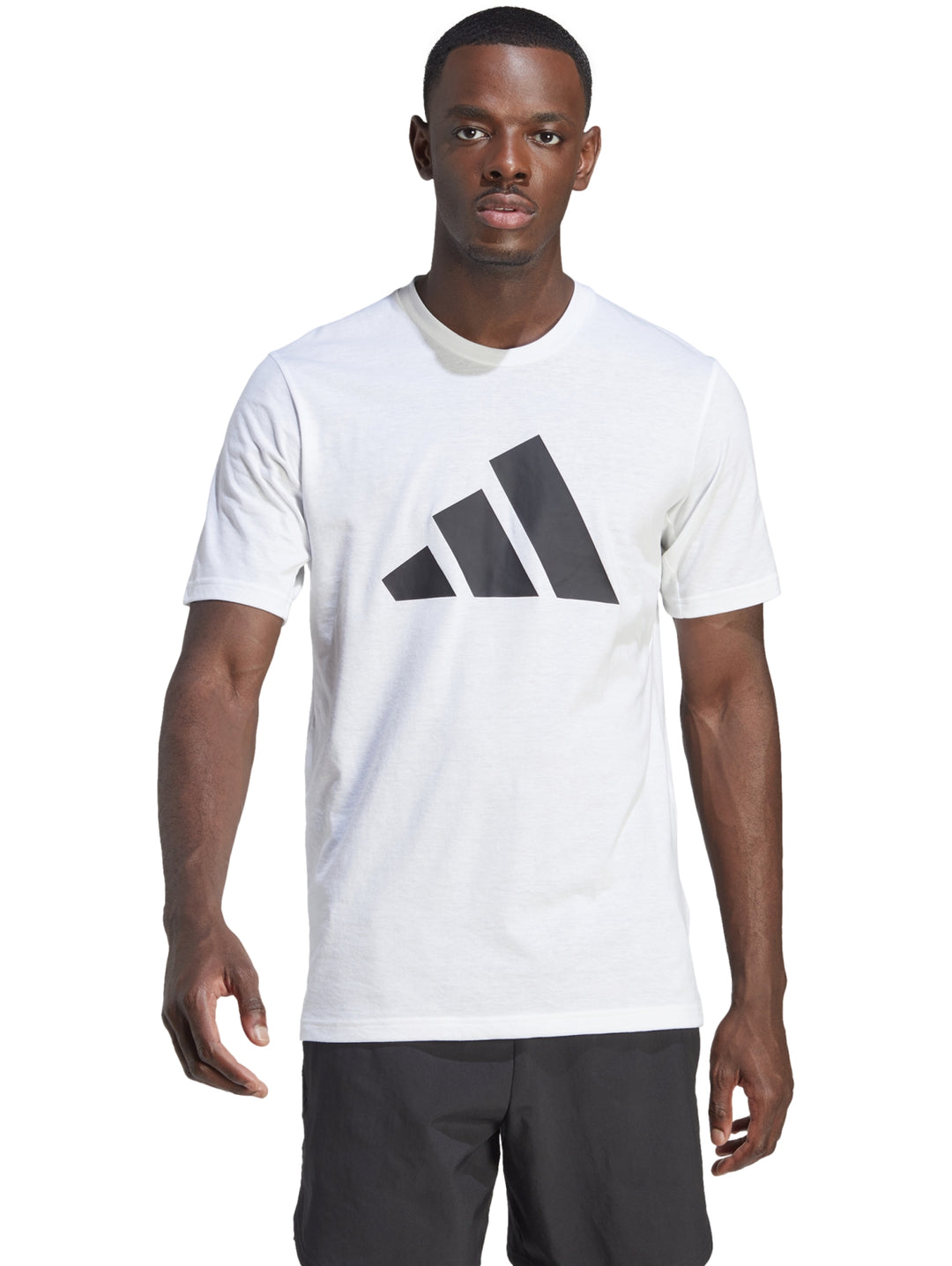 Hombre vistiendo una camiseta deportiva blanca de manga corta con logo negro de Adidas en el pecho.