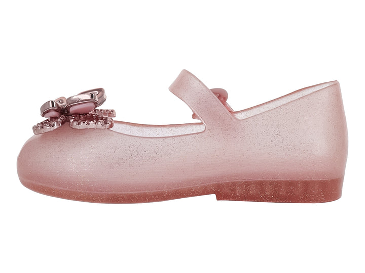 Zapato infantil Mini Melissa color rosa brillante con moño decorativo y correa ajustable.