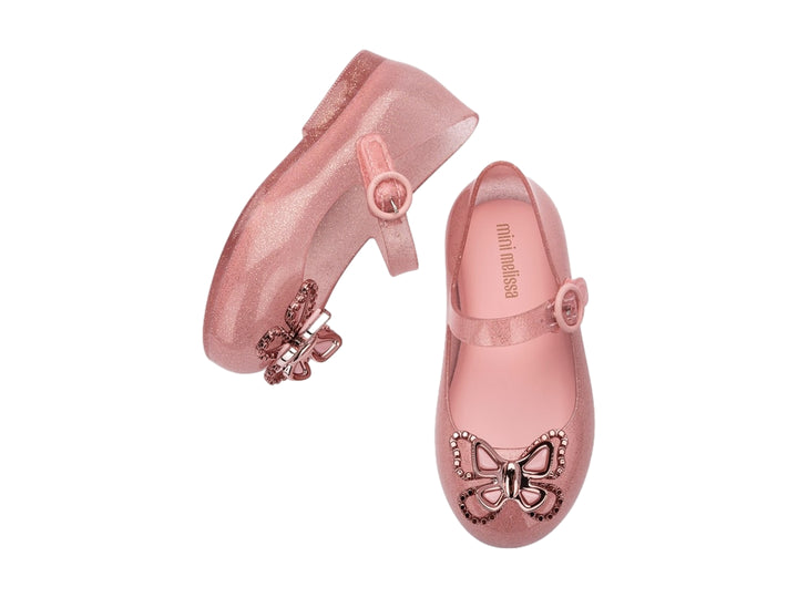 Zapato infantil Mini Melissa color rosa brillante con moño decorativo y correa ajustable.