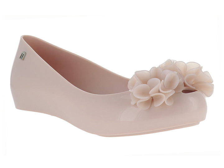 Zapato plano Melissa color rosa con detalle de flor en la punta y acabado brillante.