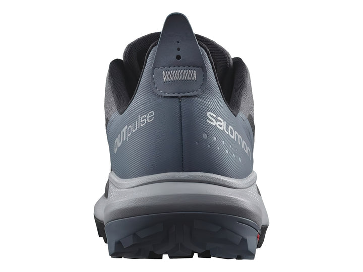 Tenis deportivos Salomon en tonos gris y azul con suela blanca y negra.