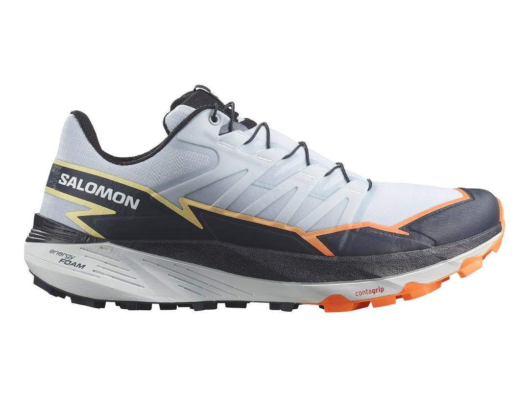Tenis Salomon Thundercross color blanco y gris con detalles en naranja y suela para trail.
