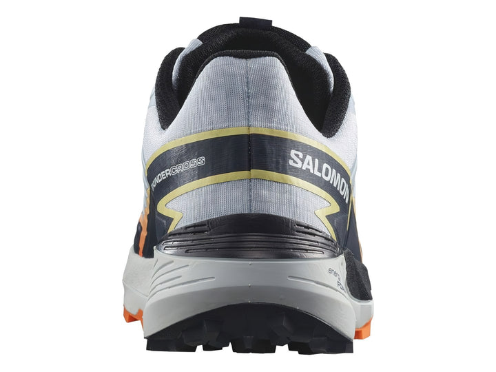 Tenis Salomon Thundercross color blanco y gris con detalles en naranja y suela para trail.
