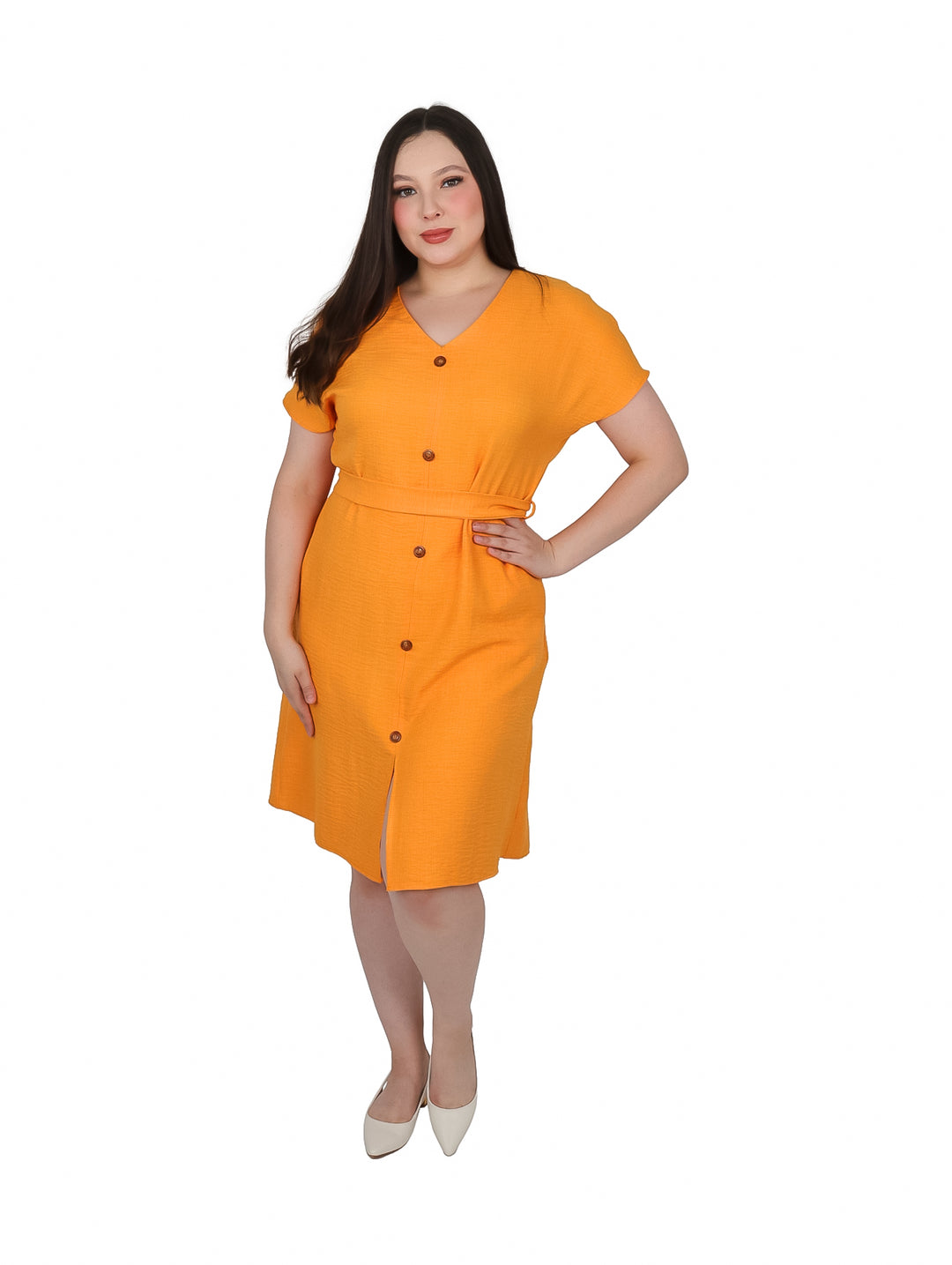 Mujer vistiendo un vestido camisero color mango con botones frontales y amarre en la cintura.