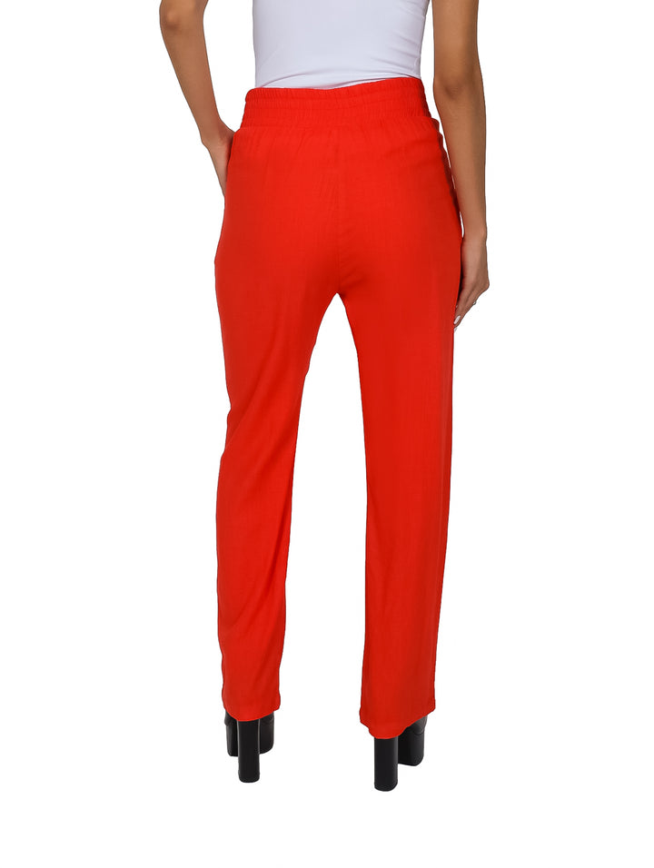 Pantalón de lino color naranja con pinzas y jareta en la cintura para mujer.