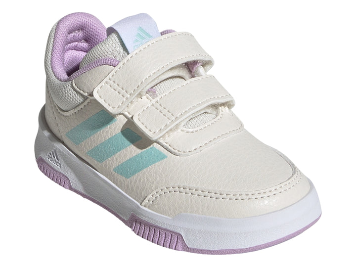 Tenis deportivos Adidas blancos con rayas azul claro, cierre de velcro y detalles en morado.