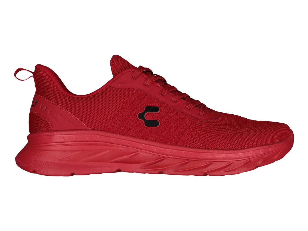 Tenis deportivos marca Charly en color rojo sólido con suela a juego y tejido transpirable.