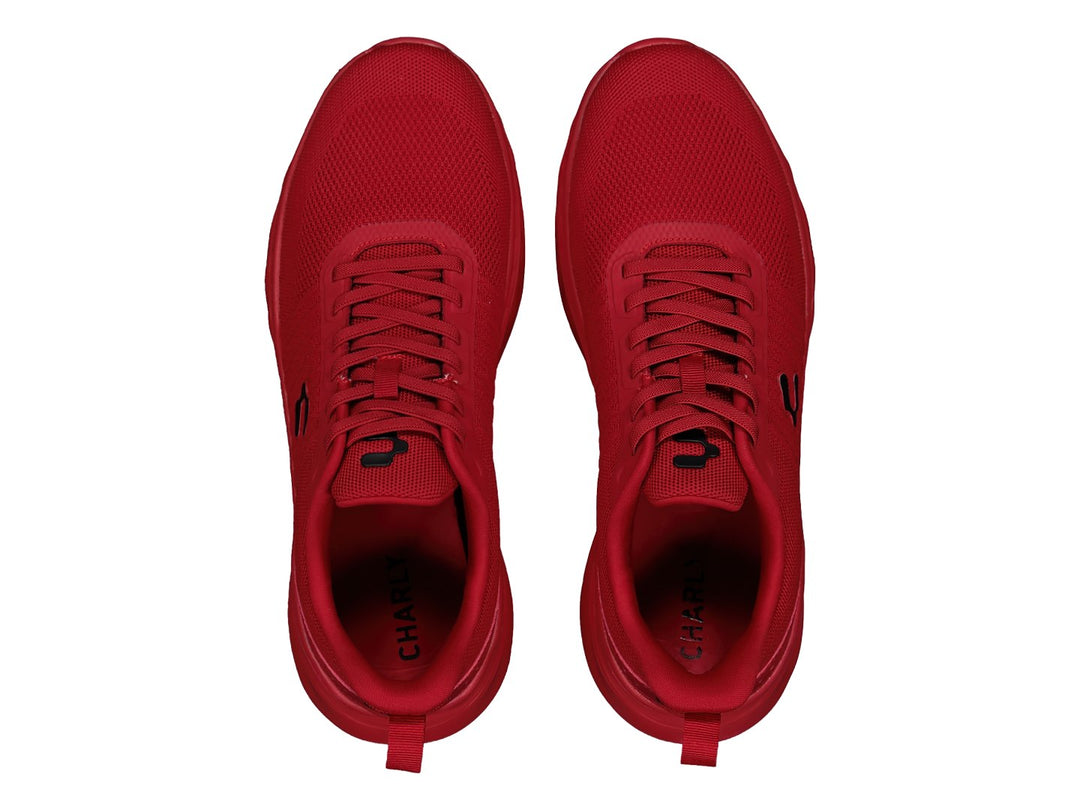 Tenis deportivos marca Charly en color rojo sólido con suela a juego y tejido transpirable.