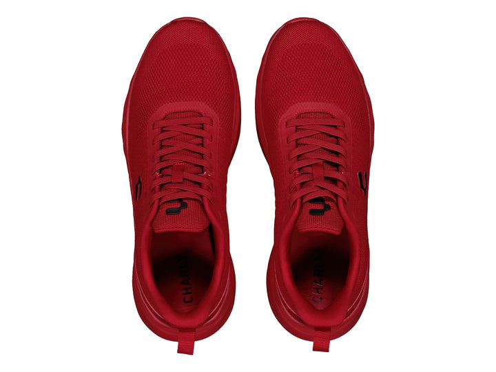 Tenis deportivos marca Charly en color rojo sólido con suela a juego y tejido transpirable.