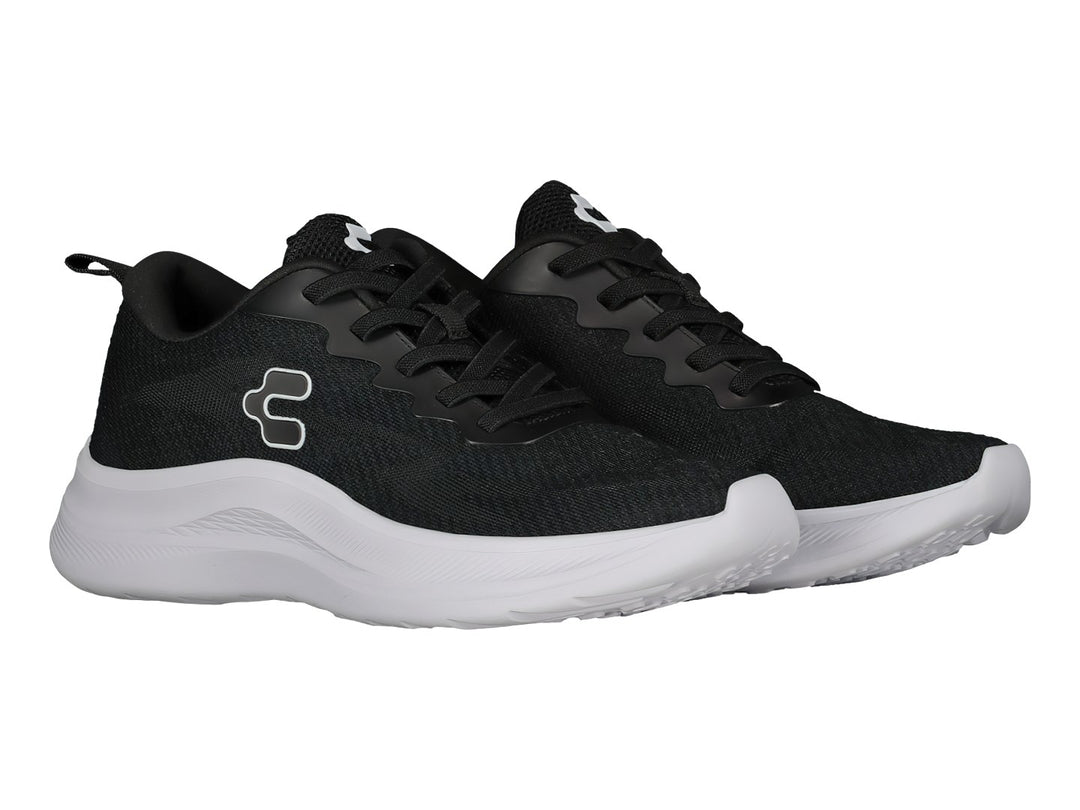 Tenis deportivos Charly color negro con suela blanca y logotipo lateral blanco.