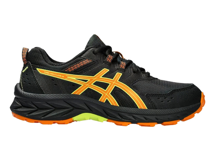 Tenis deportivos ASICS color negro con detalles en naranja y verde lima para niños.