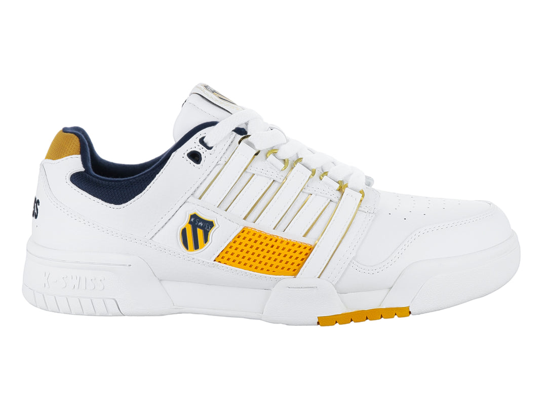Tenis K-Swiss G-Staad en color blanco con detalles en dorado y azul marino.