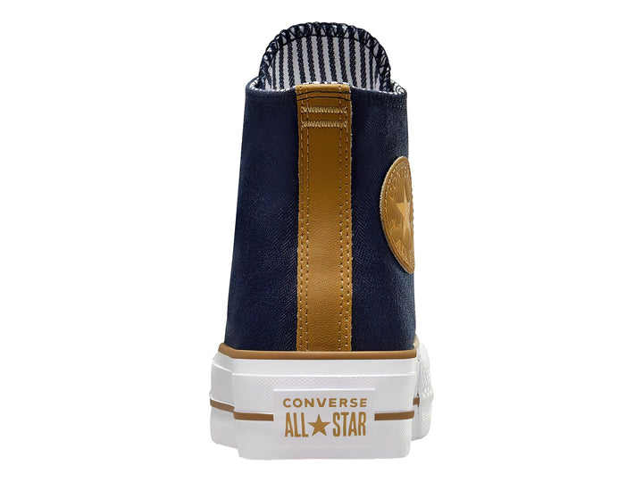 Tenis Converse Chuck Taylor All Star Lift de cuello alto color azul oscuro con suela blanca y detalles en dorado.