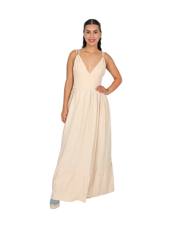 Mujer vistiendo un vestido largo de lino en color natural con escote en V y tirantes.
