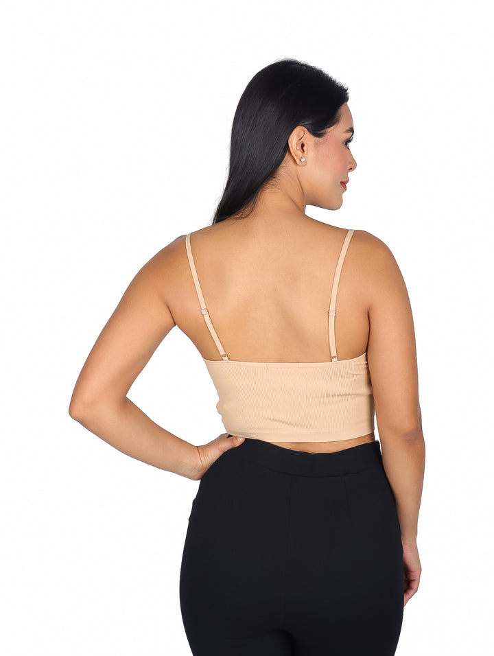 Mujer vistiendo una blusa beige de tirantes con textura rib.