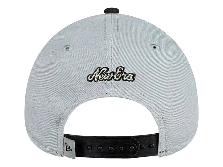 Gorra de béisbol New Era color gris con visera negra y bordado frontal en naranja y plata.
