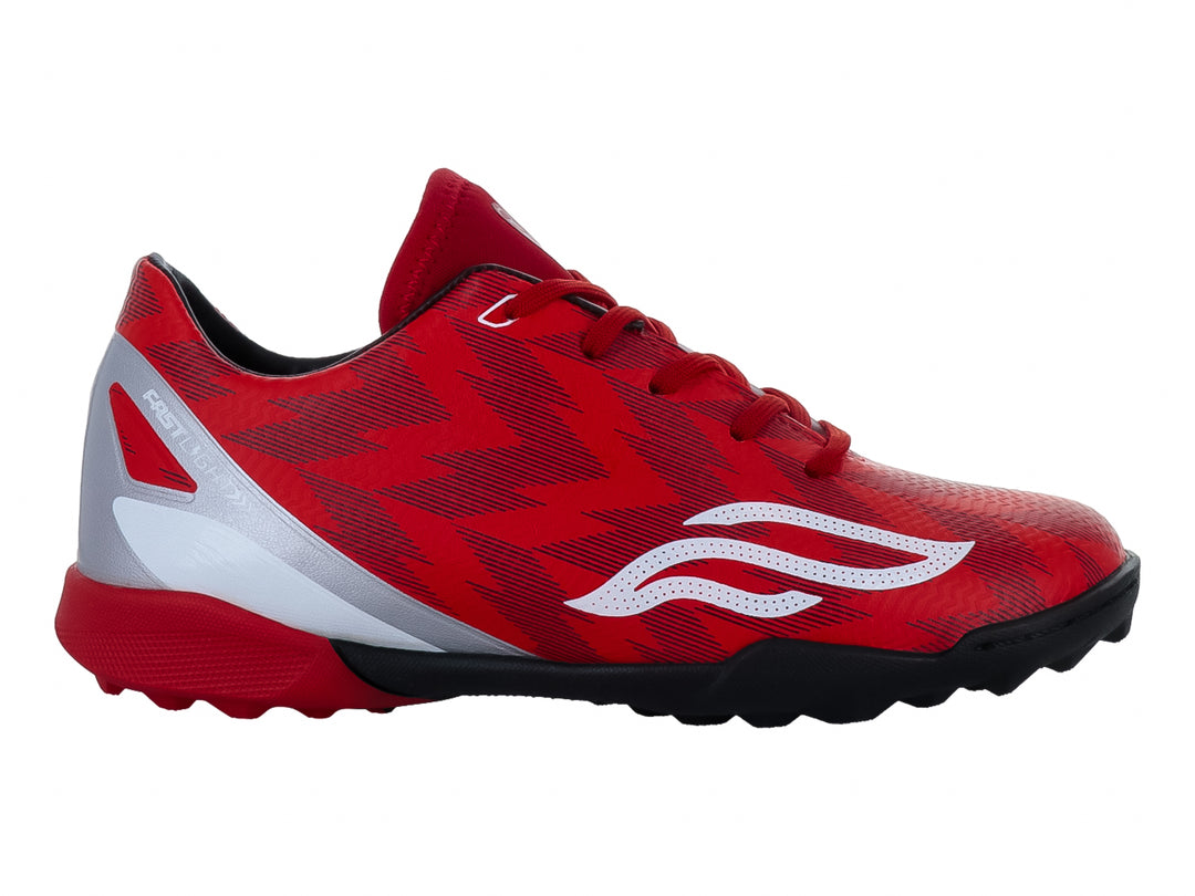 Zapato de fútbol Furia para niños en color rojo con detalles en blanco y plata y suela negra.