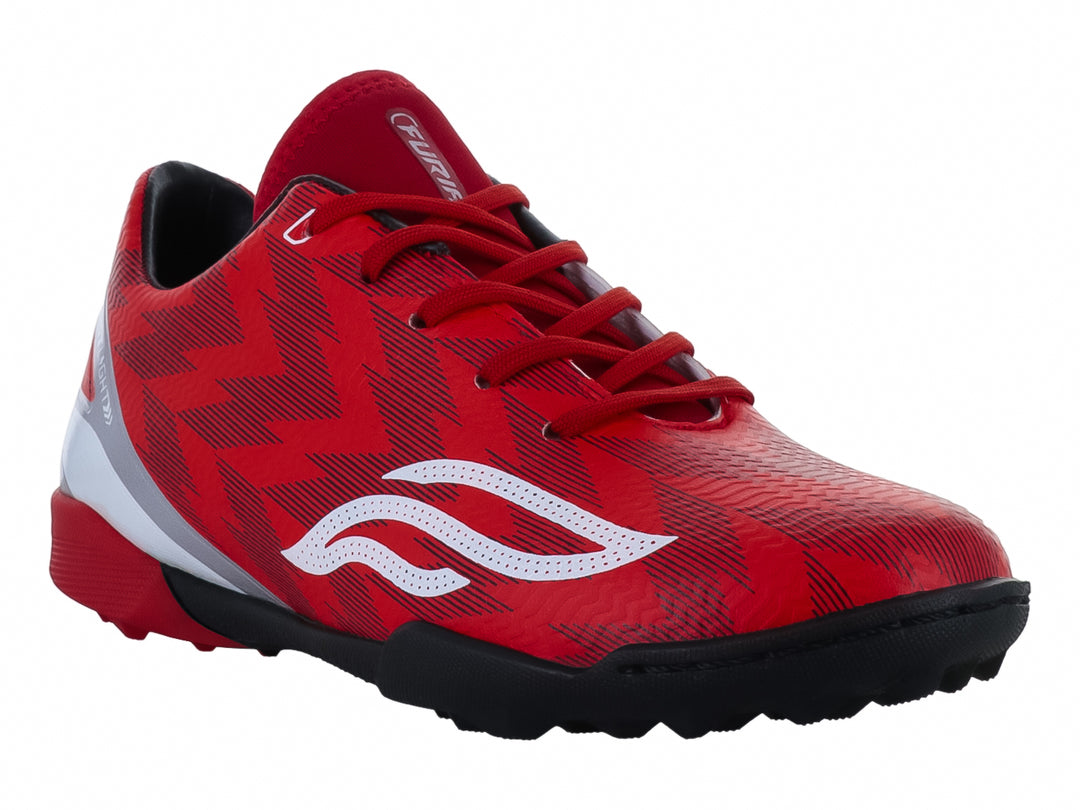 Zapato de fútbol Furia para niños en color rojo con detalles en blanco y plata y suela negra.