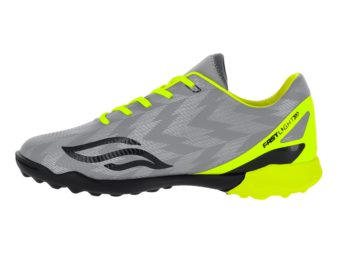 Zapato de fútbol Furia para niños en color gris con detalles en amarillo neón y suela negra para césped sintético.