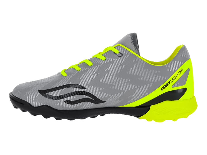 Zapato de fútbol Furia para niños en color gris con detalles en amarillo neón y suela negra para césped sintético.