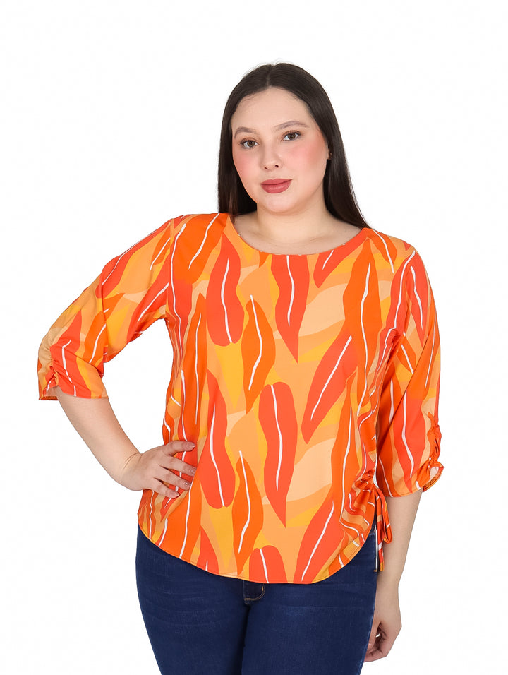 Mujer vistiendo blusa naranja con estampado abstracto y mangas 3/4.