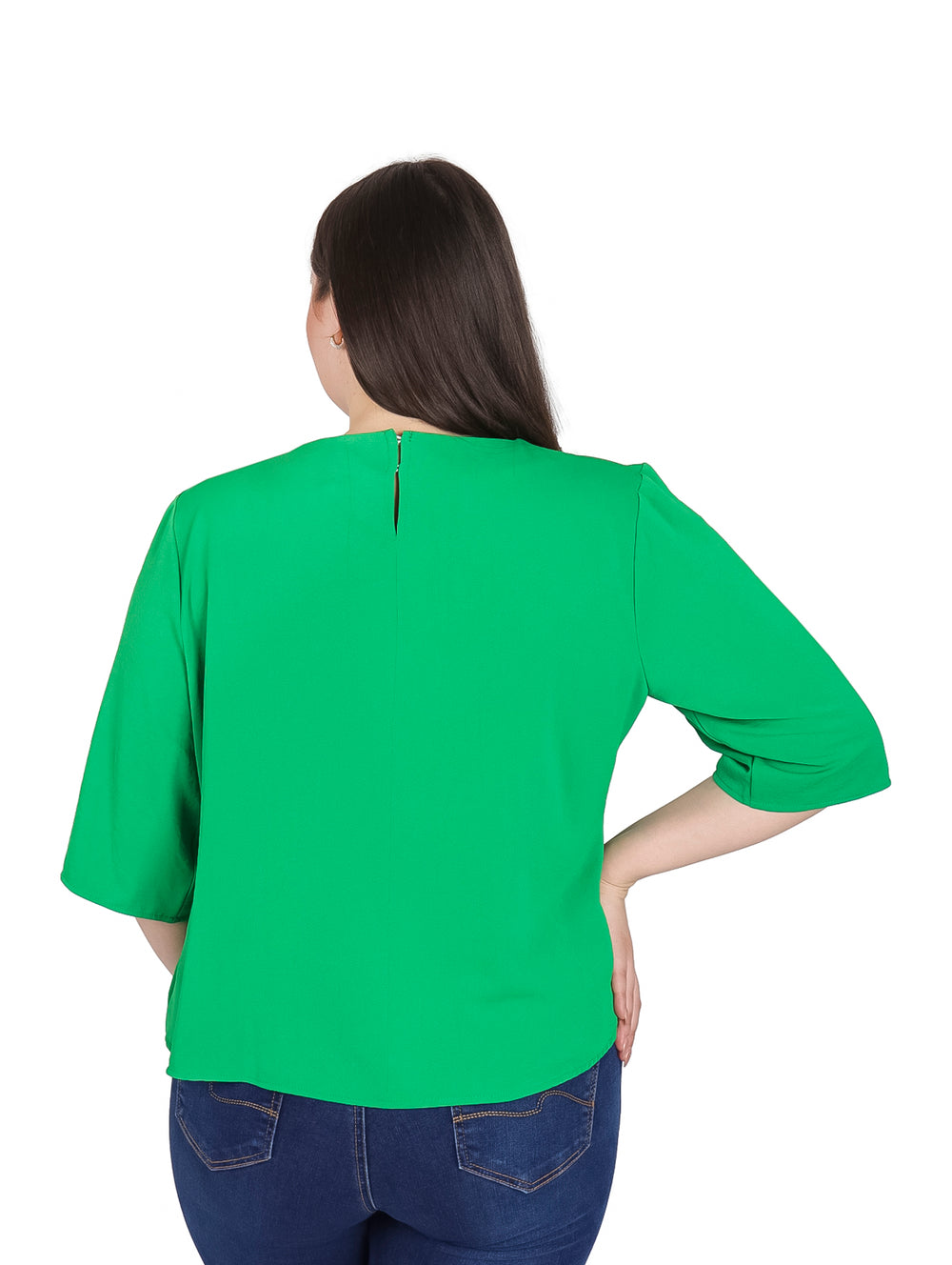 Mujer vistiendo blusa verde de manga 3/4 con detalle drapeado en el cuello y pantalones jeans azules.
